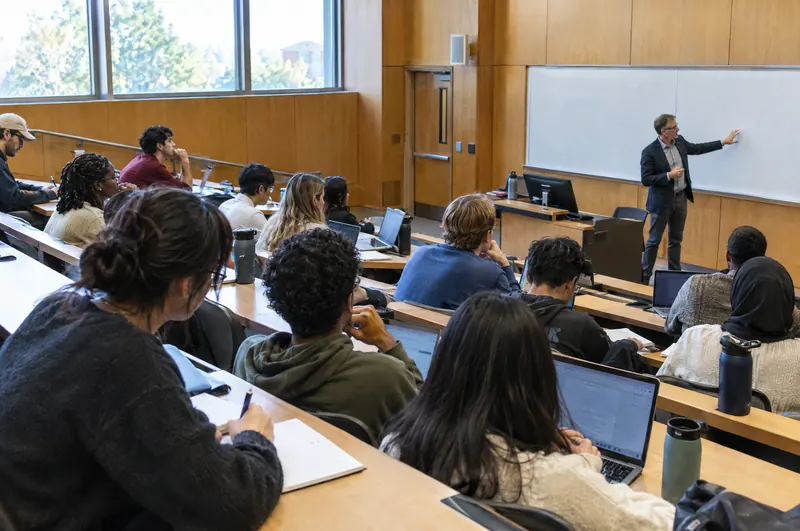 Students taking notes in a university lecture hall